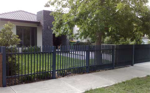 house with fencing panels attached to post