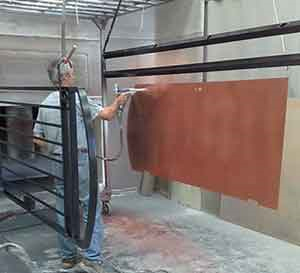 Power coating a backing sheet of a gate 