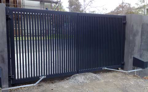 solid gate with bars with a swing gate motor installed
